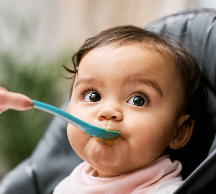 Baby being fed. Analysis Backs Early Peanut and Egg Introduction to Kids to Avoid Allergies