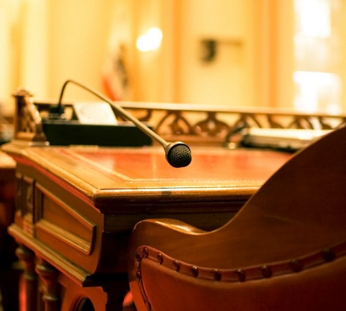 A microphone on the antique desk of a California State Senator.