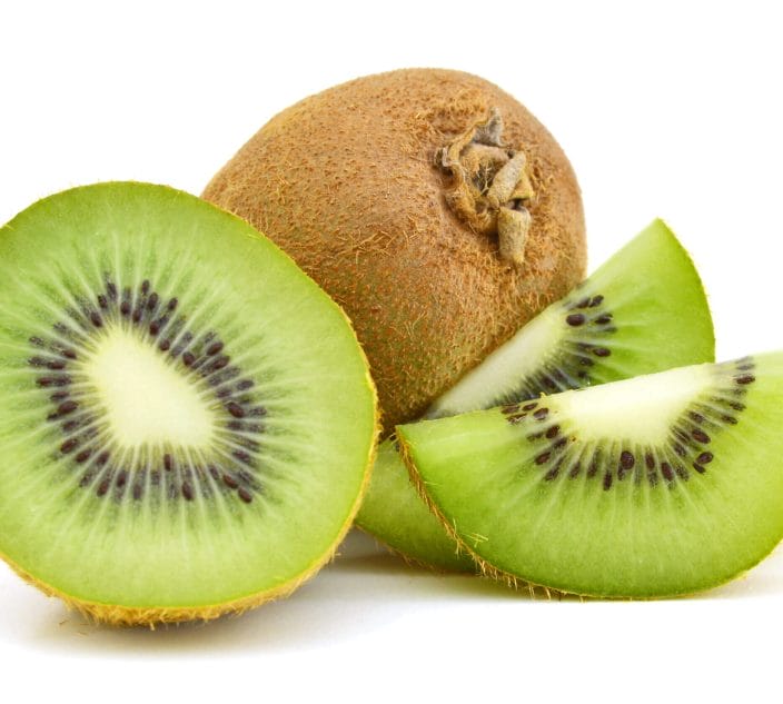 Whole kiwi fruit and sliced segments isolated on white background cutout