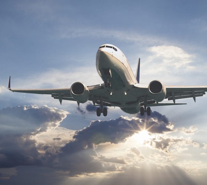 Passenger airplane taking off at sunset